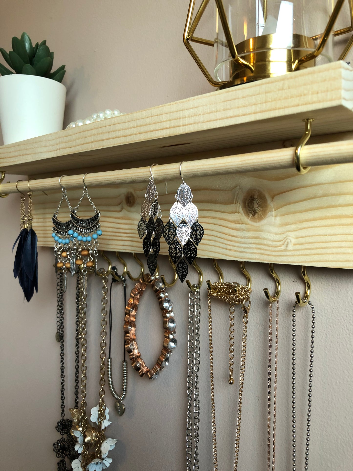 Handmade Wooden Jewellery Organiser and Earring Display featuring 13 brass hooks and a 9mm wooden dowel for versatile storage. Sleek Dark Walnut stain enhances its timeless elegance. Customize with brass or upgrade to silver/chrome hooks and D rings. Accessorize your decor effortlessly.