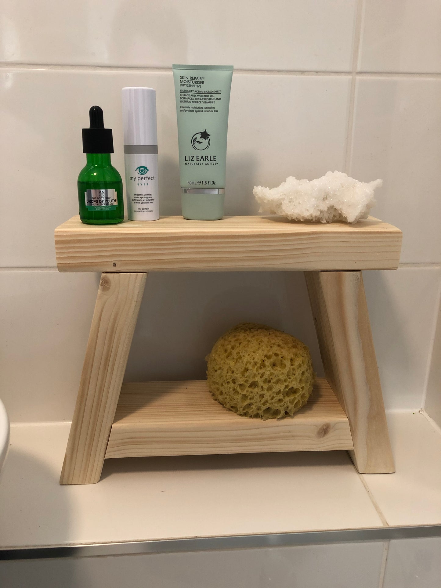 Handmade small rustic-style display stool with chunky shelves, perfect for living rooms, kitchens, and bathrooms. Ideal for house plants, beauty products, cosmetics, and candles. Made to order with options of Rustic Oak, Fir Cone, or Plain Untreated finish. Measurements: Total Height 10 inches, Width 11.75 inches, Depth 3.5 inches. Crafted with care, ensuring each piece is inspected for beauty and quality.