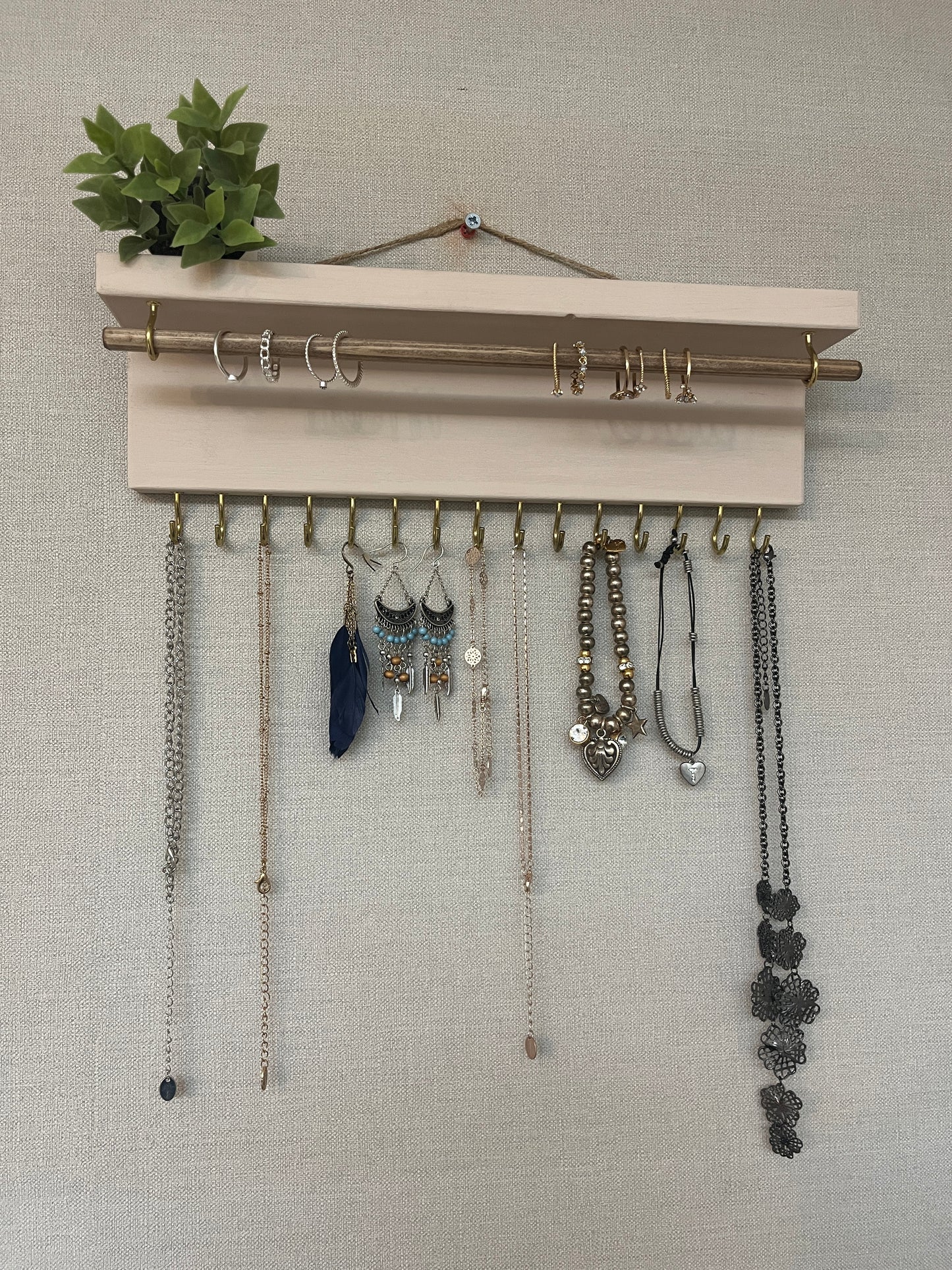 Handmade premium jewellery organizer crafted from timber, featuring 15 hooks for rings, necklaces, earrings, and bracelets. Top shelf for small items. Compact design, easy to hang, customizable color. Perfect gift for fashion lovers.
