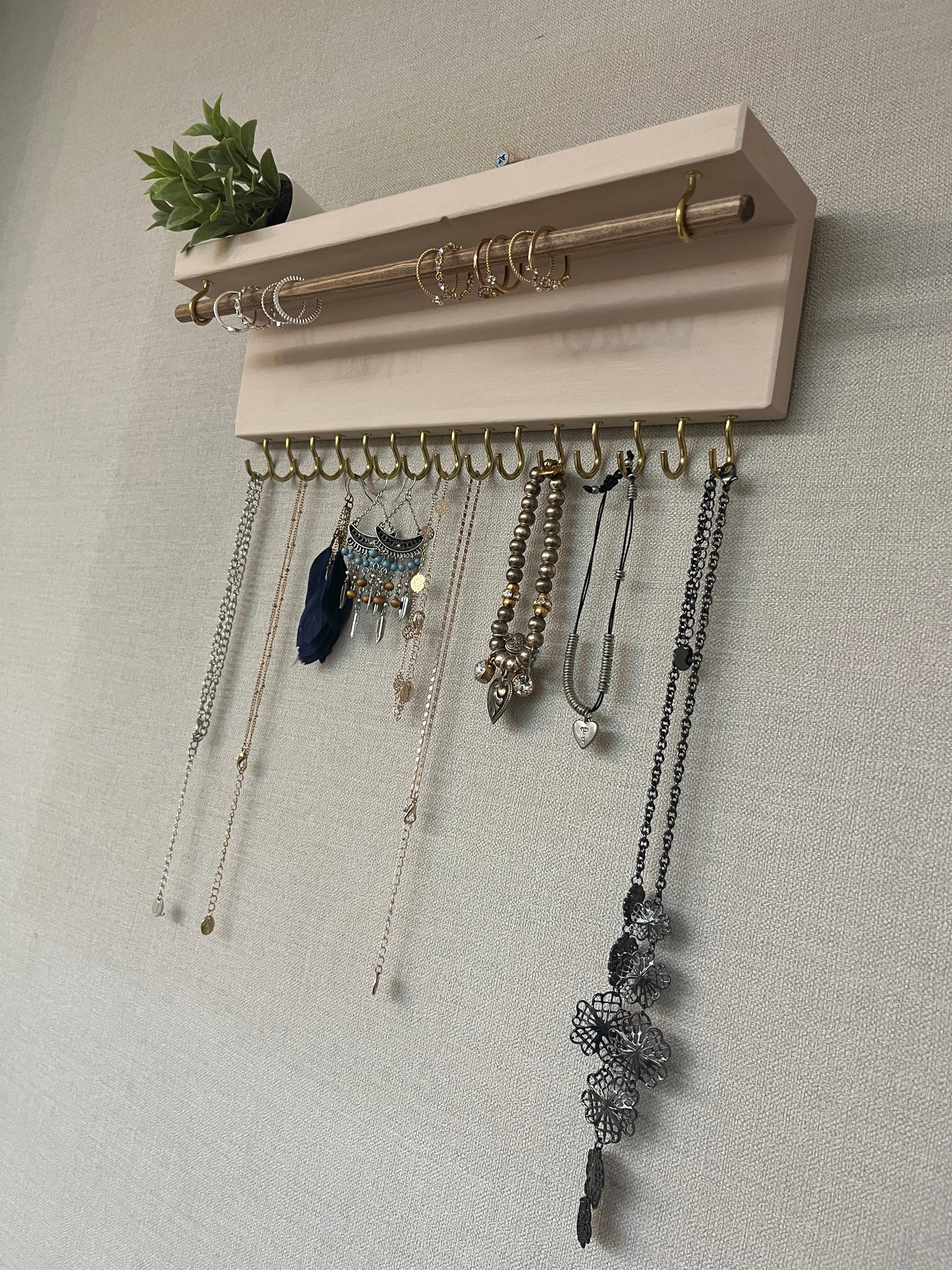 Handmade premium jewellery organizer crafted from timber, featuring 15 hooks for rings, necklaces, earrings, and bracelets. Top shelf for small items. Compact design, easy to hang, customizable color. Perfect gift for fashion lovers.
