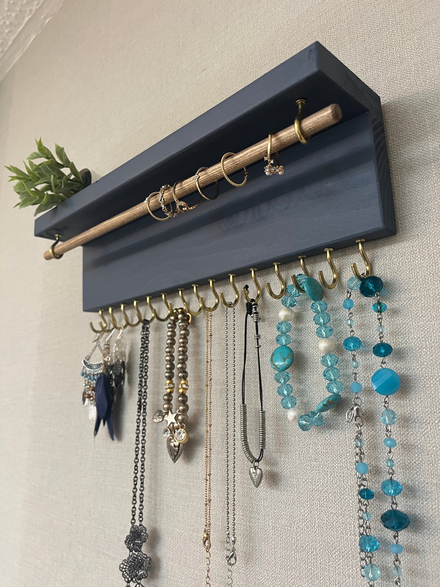 Handmade premium jewellery organizer crafted from timber, featuring 15 hooks for rings, necklaces, earrings, and bracelets. Top shelf for small items. Compact design, easy to hang, customizable color. Perfect gift for fashion lovers.