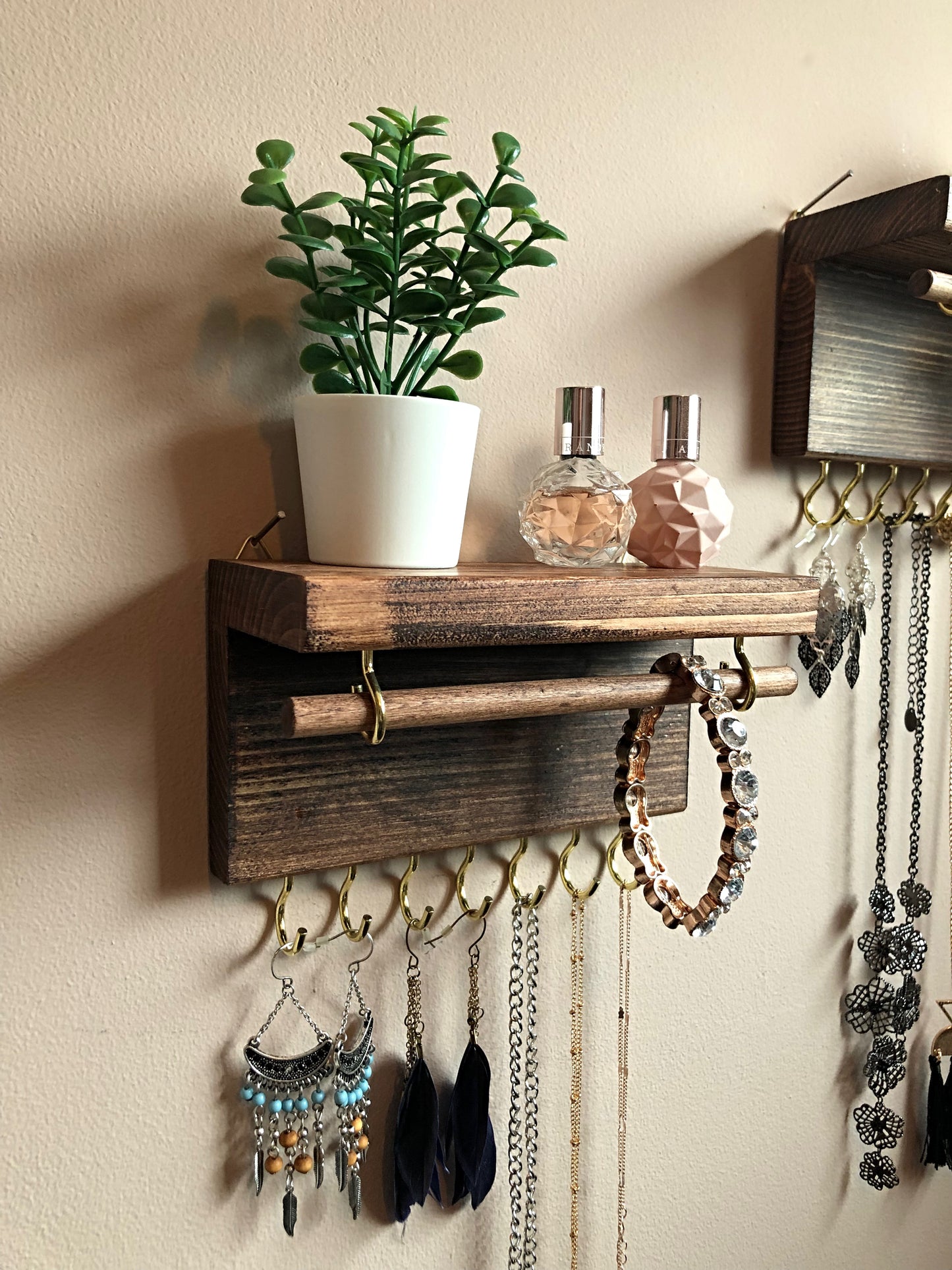 Handmade wooden jewellery organizers and earring displays in various finishes including Rustic Oak and Ebony. Each organizer features 7 brass hooks for ample storage. Perfect for showcasing necklaces, bracelets, and earrings. Customize with brass or upgrade to silver/chrome hooks and D rings