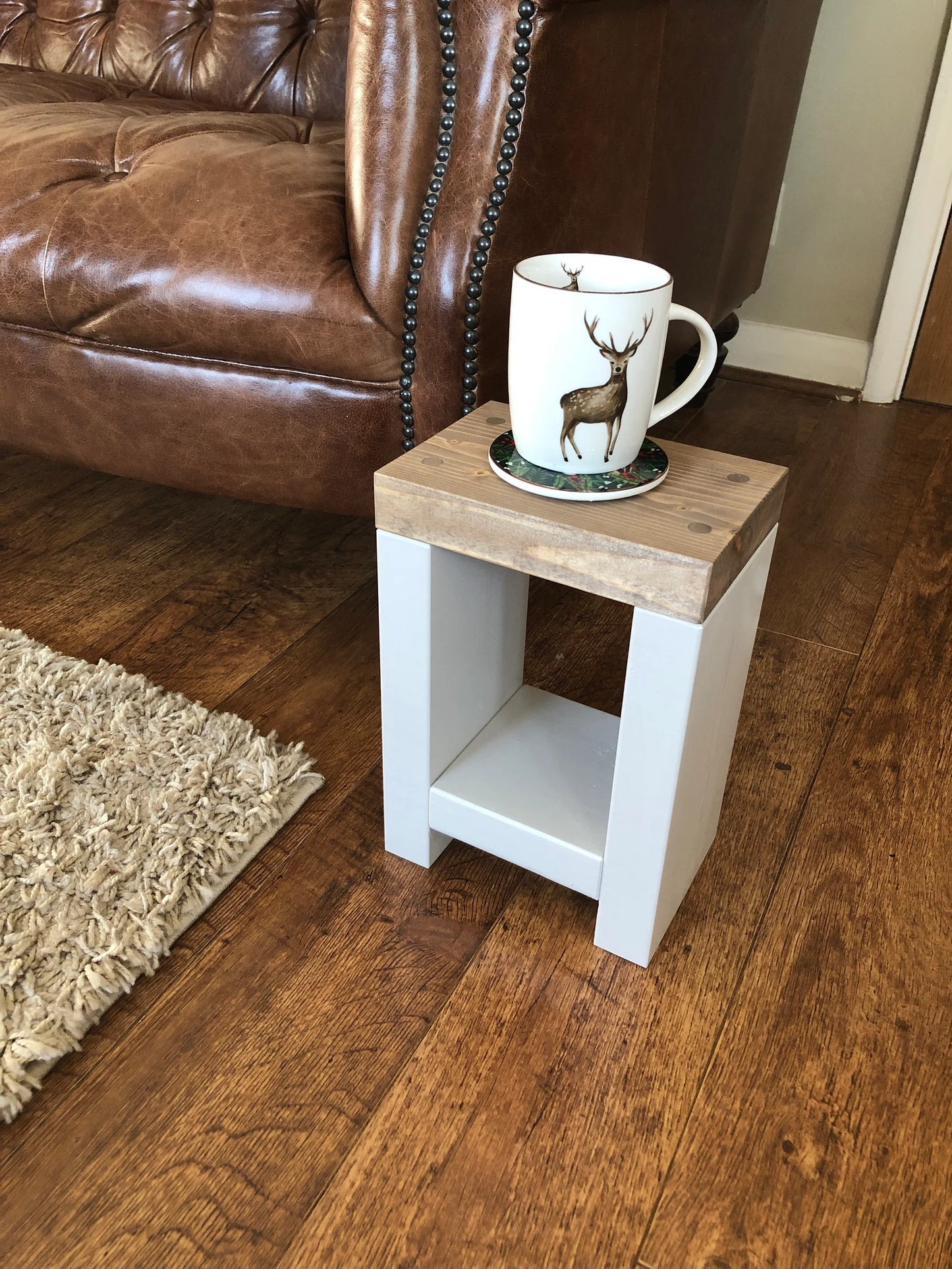 Artisan-crafted from premium timber, this small side table exudes character and elegance with its hand-applied finish in Farrow and Ball colors. Perfect for adding a bespoke touch to your decor, its carefully chosen hues enhance the table's natural beauty while seamlessly blending with any interior style. Elevate your space with this unique piece of furniture, meticulously crafted to bring warmth and sophistication to your home