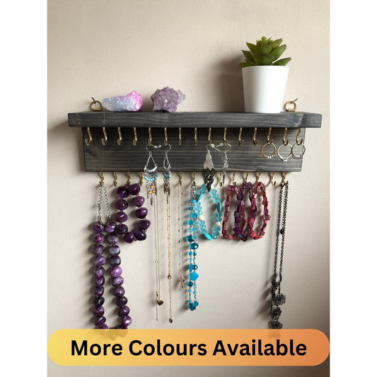 Wall-mounted jewellery organiser with 30 hooks, available in various colours including Woodland and Rustic Oak. Handcrafted from carefully selected timber, each piece boasts unique natural grain patterns. Customize with brass or upgrade to silver/chrome hooks and D rings
