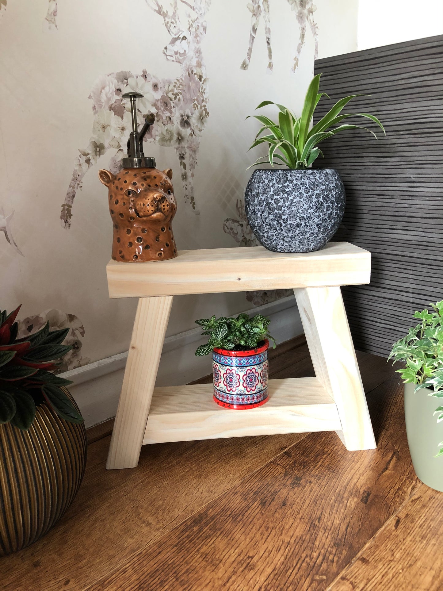Handmade small rustic-style display stool with chunky shelves, perfect for living rooms, kitchens, and bathrooms. Ideal for house plants, beauty products, cosmetics, and candles. Made to order with options of Rustic Oak, Fir Cone, or Plain Untreated finish. Measurements: Total Height 10 inches, Width 11.75 inches, Depth 3.5 inches. Crafted with care, ensuring each piece is inspected for beauty and quality.