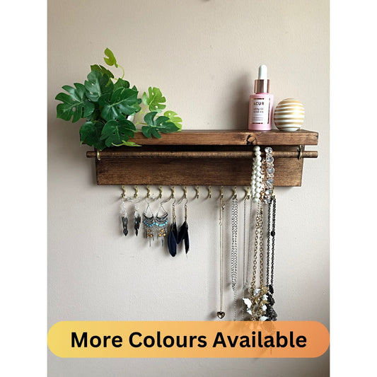  Handmade Wooden Jewellery Organiser and Earring Display featuring 13 brass hooks and a 9mm wooden dowel for versatile storage. Sleek Dark Walnut stain enhances its timeless elegance. Customize with brass or upgrade to silver/chrome hooks and D rings. Accessorize your decor effortlessly.