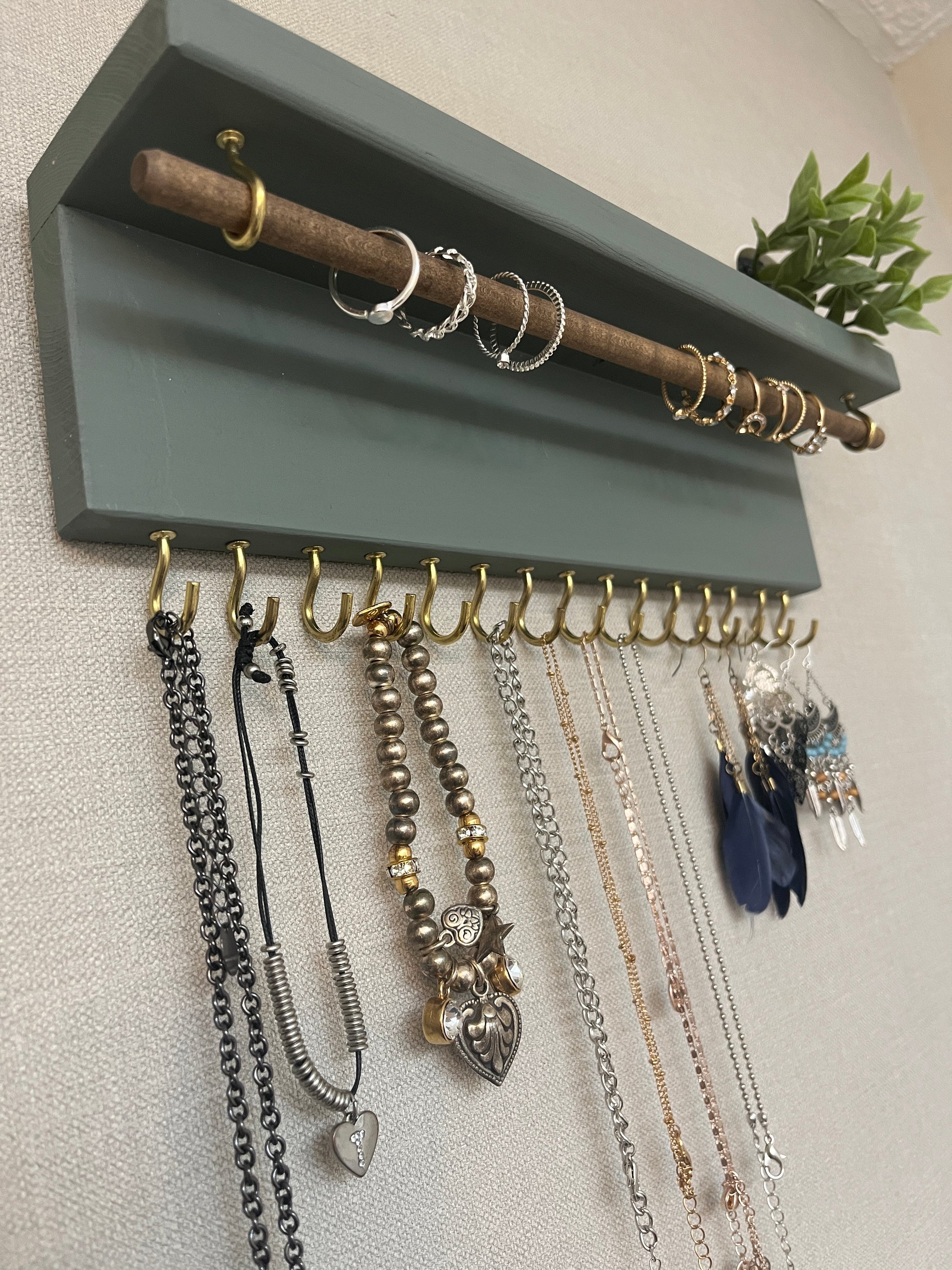 Handmade premium jewellery organizer crafted from timber, featuring 15 hooks for rings, necklaces, earrings, and bracelets. Top shelf for small items. Compact design, easy to hang, customizable color. Perfect gift for fashion lovers.
