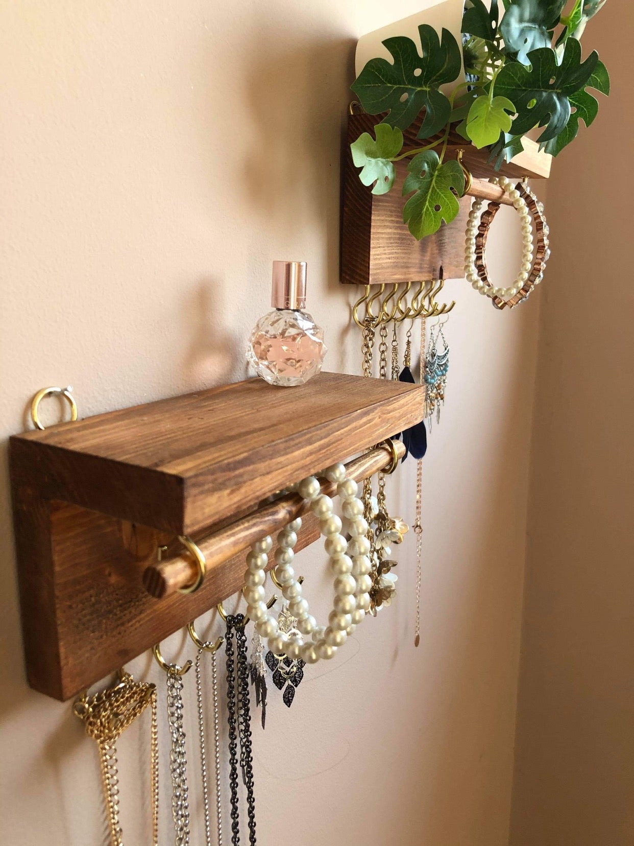 Handmade wooden jewellery organizers and earring displays in various finishes including Rustic Oak and Ebony. Each organizer features 7 brass hooks for ample storage. Perfect for showcasing necklaces, bracelets, and earrings. Customize with brass or upgrade to silver/chrome hooks and D rings