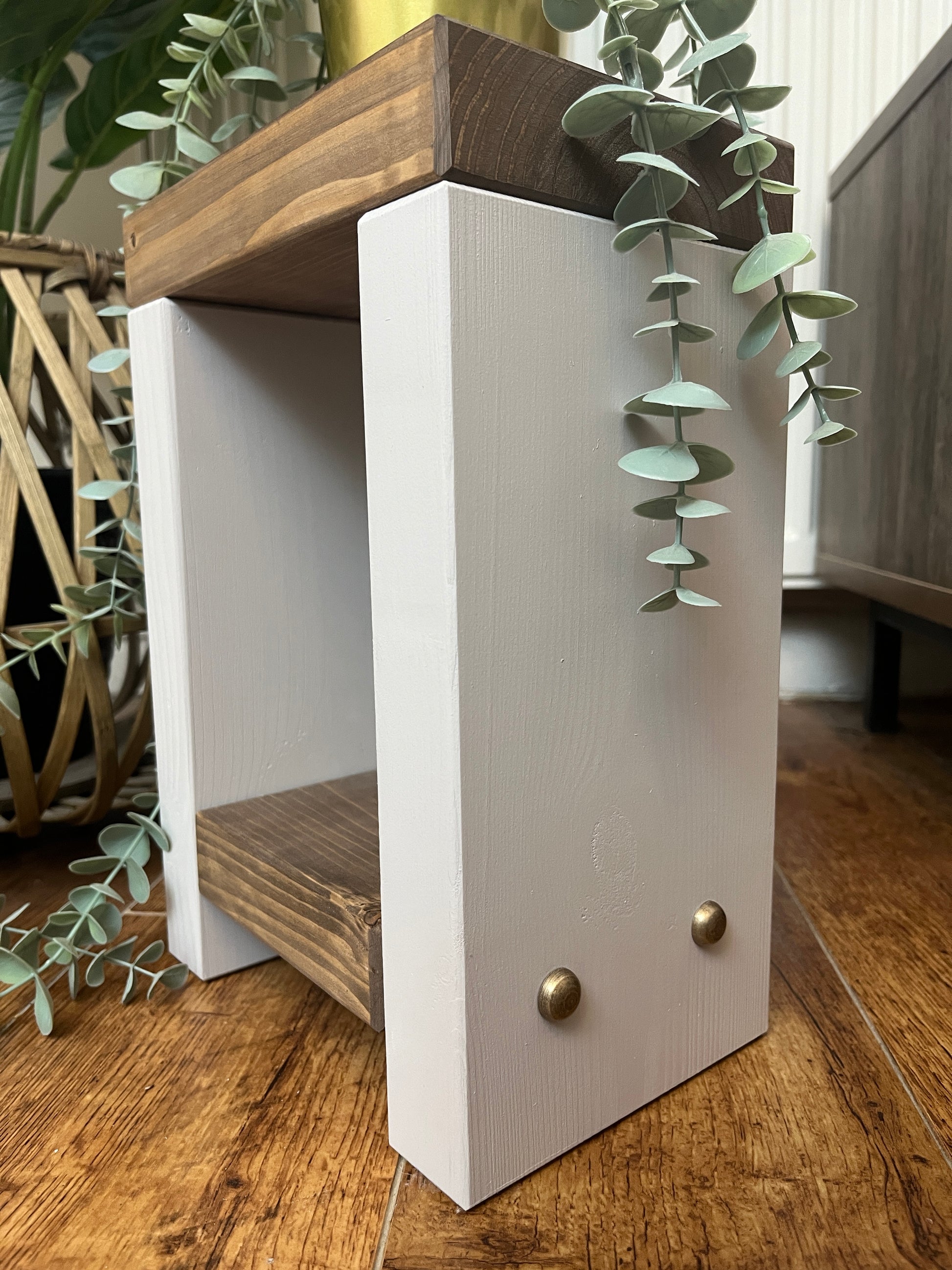 Handmade Mini Side Table crafted from handpicked timber, ideal for cozy corners or snug living areas. Features a top surface for showcasing plants or candles and a low shelf for clutter-free storage. Handmade to order with a durable finish. Customizable with two-tone effect and Farrow and Ball colors. Dimensions: H: 29.5cm, W: 20cm, D: 14cm, Height between shelf and top: 18cm