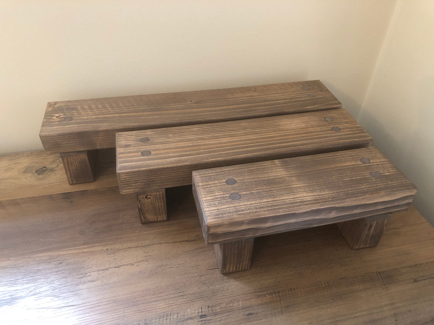 "Simple riser shelf handmade from rustic timber, perfect for any room. Ideal for windowsills, dressing tables, kitchen worktops, or bathrooms. Available in Woodland, Autumn Leaves, Fir Cone, Rustic Oak, Fresh Pine, Farmhouse Pine, Ebony. Custom sizes: Small, Medium, Large. Dimensions: Large - Length 450mm, Width 89mm, Height 99mm."