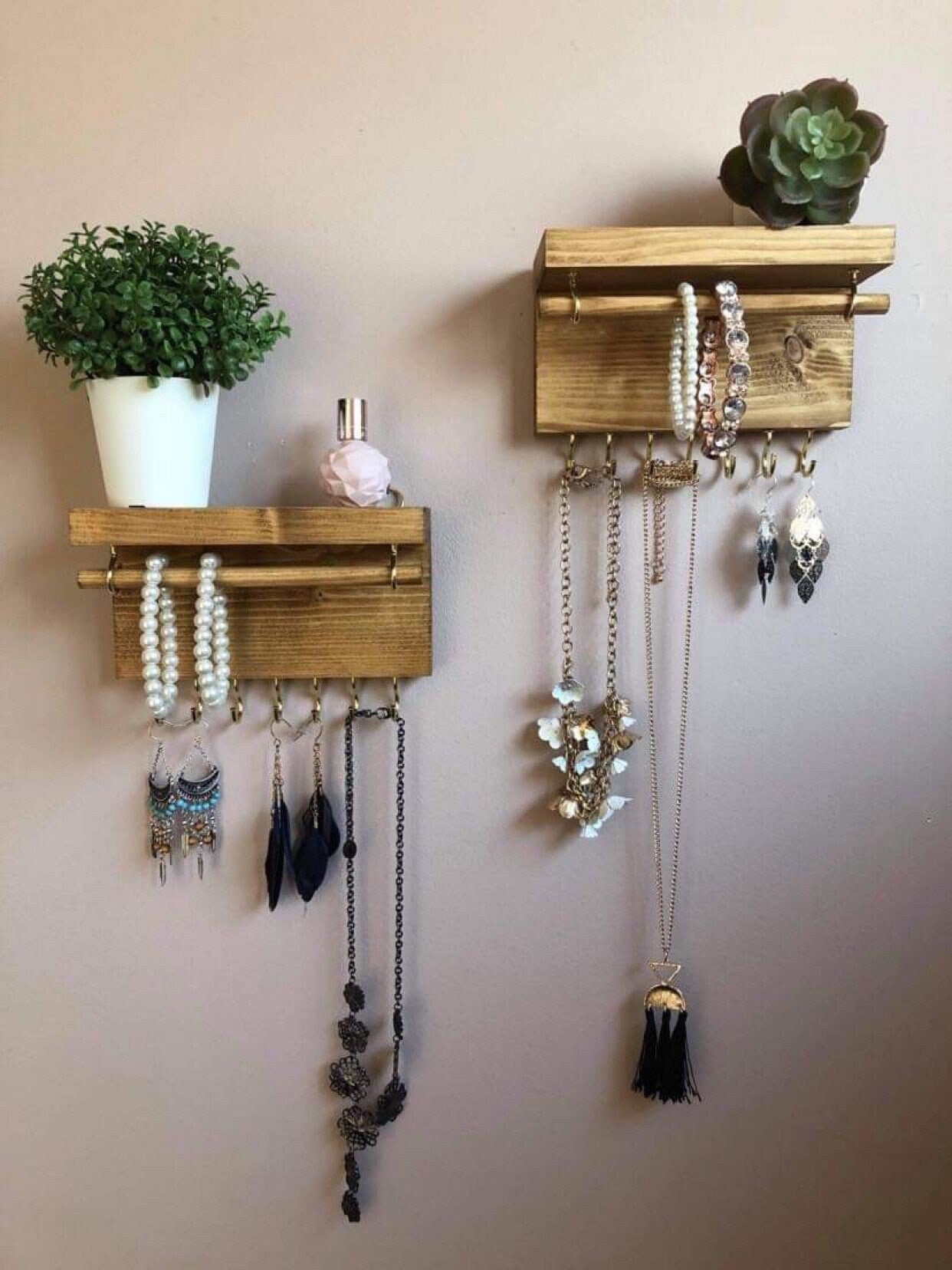 Handmade wooden jewellery organizers and earring displays in various finishes including Rustic Oak and Ebony. Each organizer features 7 brass hooks for ample storage. Perfect for showcasing necklaces, bracelets, and earrings. Customize with brass or upgrade to silver/chrome hooks and D rings