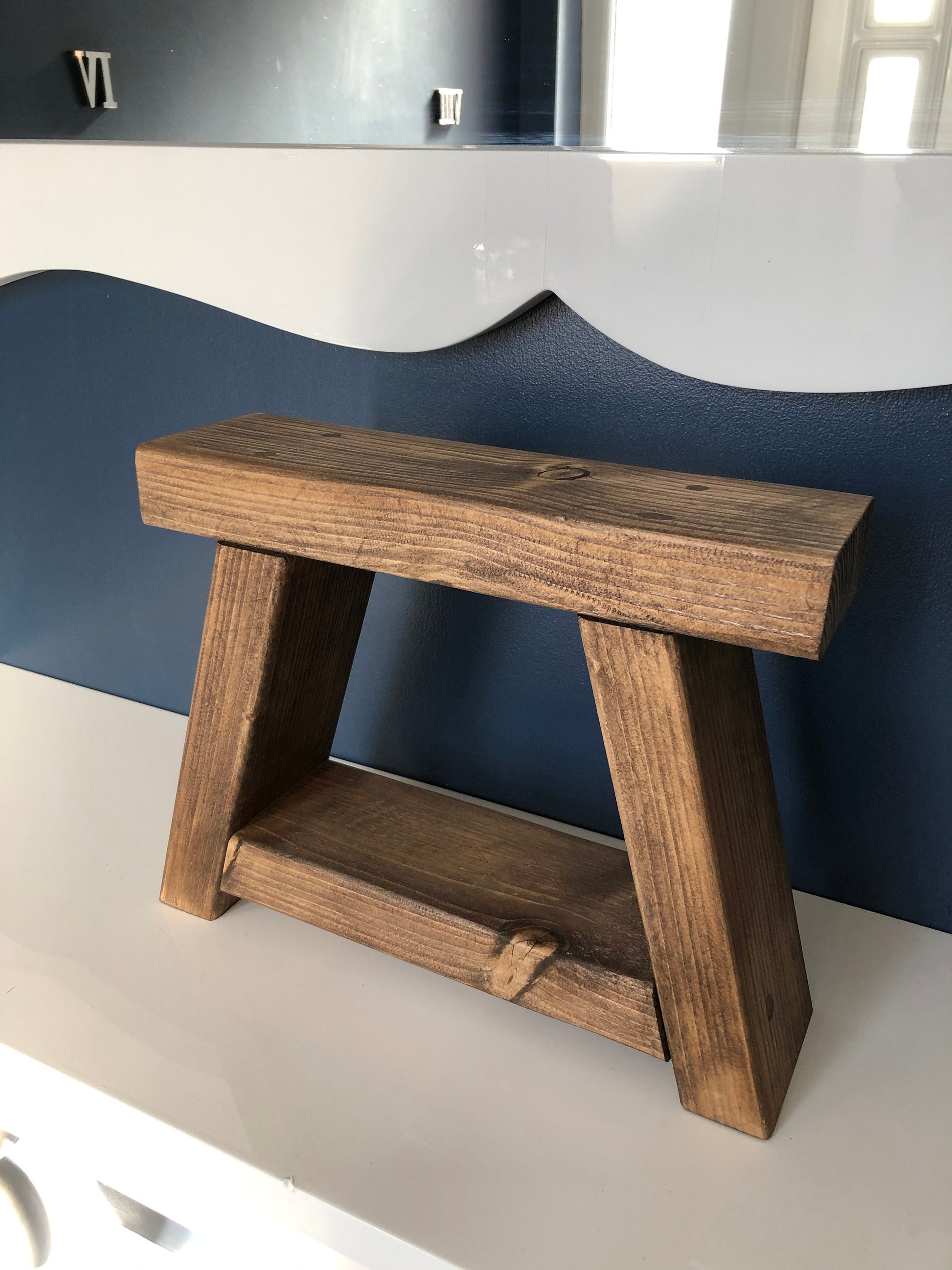Handmade small rustic-style display stool with chunky shelves, perfect for living rooms, kitchens, and bathrooms. Ideal for house plants, beauty products, cosmetics, and candles. Made to order with options of Rustic Oak, Fir Cone, or Plain Untreated finish. Measurements: Total Height 10 inches, Width 11.75 inches, Depth 3.5 inches. Crafted with care, ensuring each piece is inspected for beauty and quality.