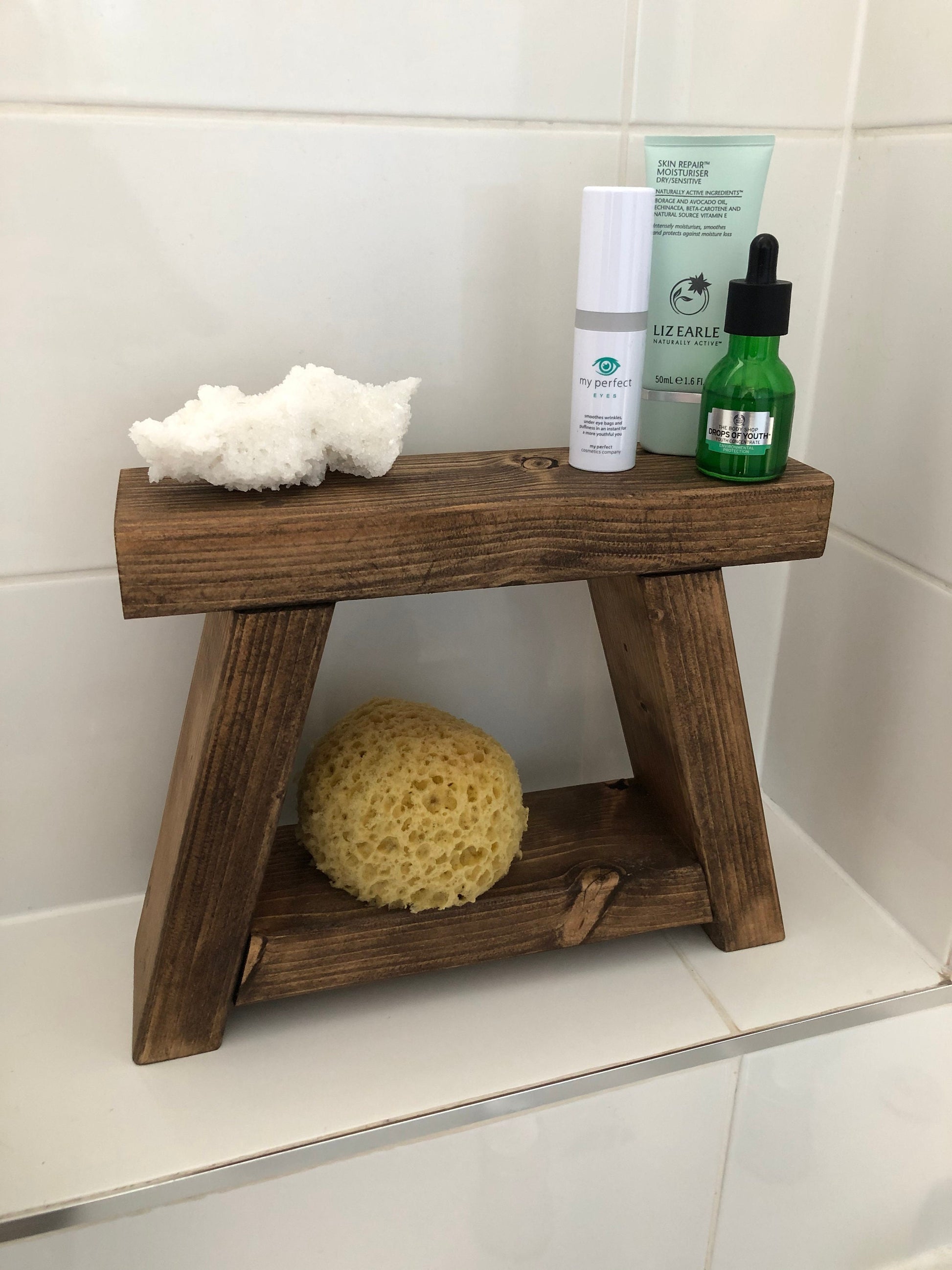 Handmade small rustic-style display stool with chunky shelves, perfect for living rooms, kitchens, and bathrooms. Ideal for house plants, beauty products, cosmetics, and candles. Made to order with options of Rustic Oak, Fir Cone, or Plain Untreated finish. Measurements: Total Height 10 inches, Width 11.75 inches, Depth 3.5 inches. Crafted with care, ensuring each piece is inspected for beauty and quality.